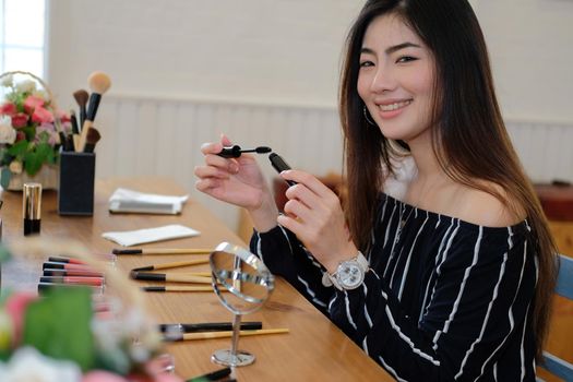 asian woman applying makeup cosmetic. make up beauty concept