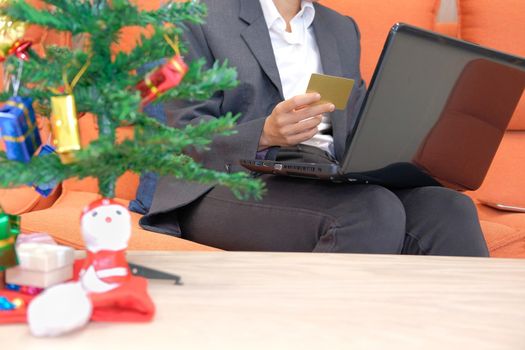 woman holding credit card & computer for online shopping.  businesswoman buying christmas gift on internet. new year holiday merry xmas celebration