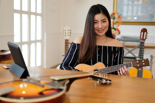 woman playing guitar at home.  leisure lifestyle concept