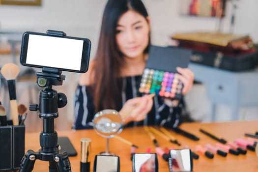 beauty blogger live broadcasting cosmetic makeup tutorial on social media. vlogger recording vlog video. influencer marketing