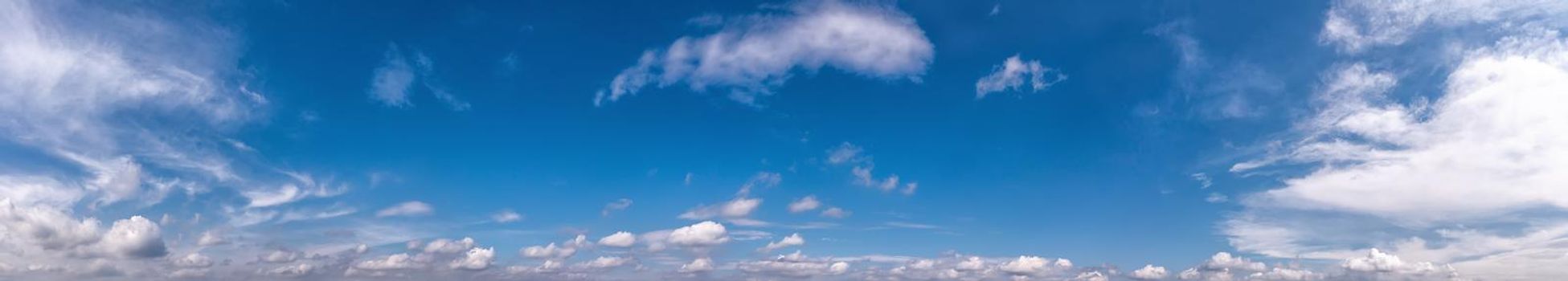 Background banner view of blue sky with fluffy clouds