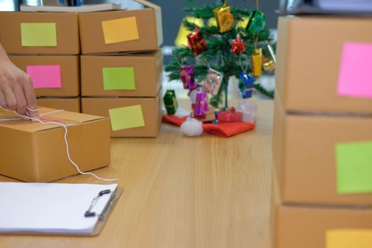 startup small business owner packing cardboard box at workplace. freelance man entrepreneur seller prepare product parcel box for deliver to customer. Online selling, e-commerce concept