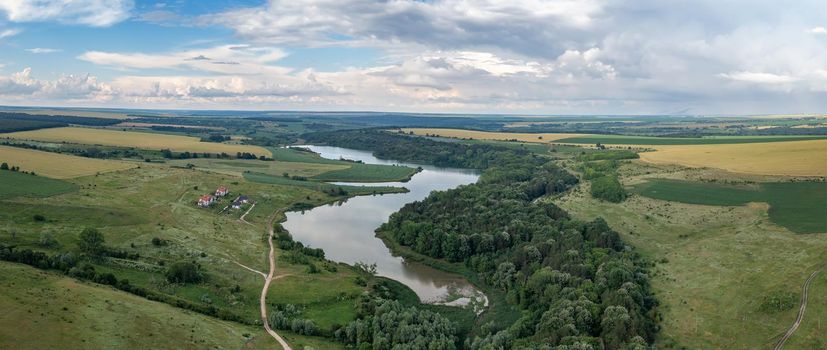 Panoramic aerial view from the drone of beautiful countryside with lake like a snake
