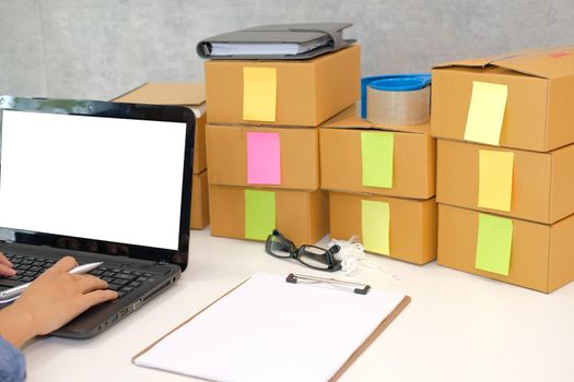startup small business owner working with computer at workplace. freelance man seller check product order for delivery. Online selling, e-commerce concept