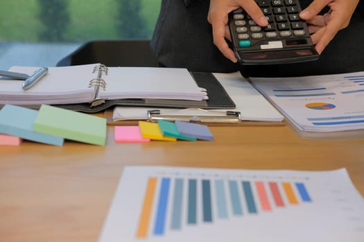 financial adviser working with calculator at office. accountant doing accounting & calculating revenue & budget. bookkeeper making calculation. finance & economy concept