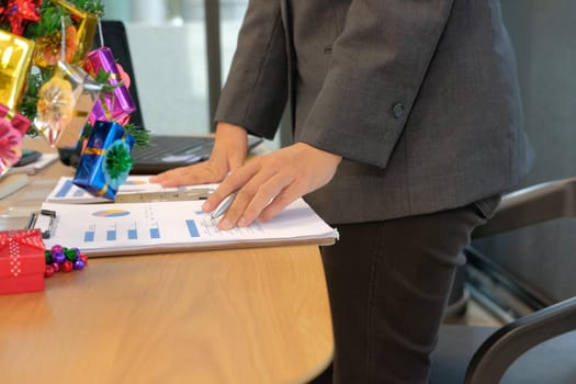 startup businessman working with document at office. young man entrepreneur analyze financial data at workplace during christmas new year holiday