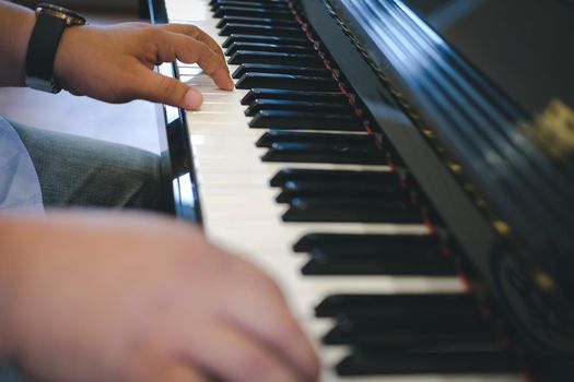 pianist man's hand playing piano. performer & classical music instrument