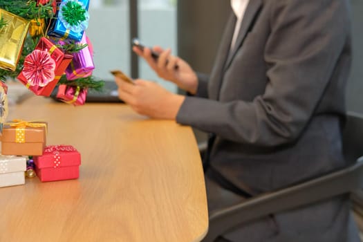 woman holding credit card using smart phone for online shopping. businesswoman buying on internet, make payment on website during christmas new year holiday