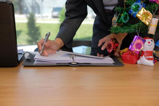 man writing reminder schedule note on notebook. businessman working organizing plan with tablet at workplace office