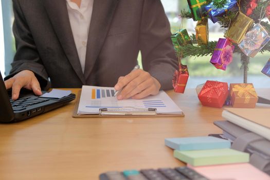 businessman using computer. startup man working with document at office. young male entrepreneur analyze financial data at workplace during christmas new year holiday