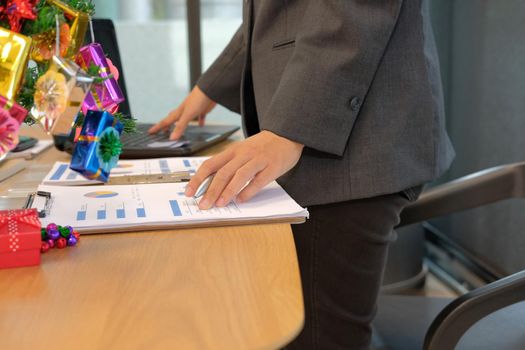 businessman using computer. startup man working with document at office. young male entrepreneur analyze financial data at workplace during christmas new year holiday