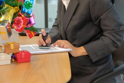 businessman using stamper for stamping approved on contract agreement document during christmas holiday