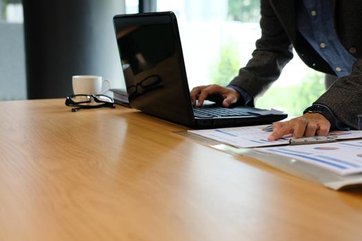 man using computer. businessman working with financial graph chart diagram