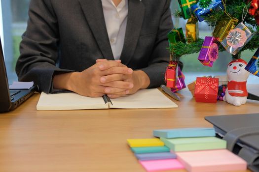 man hand on notebook. businessman working at workplace office during christmas new year holiday