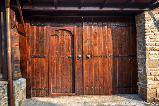 Old vintage wooden door ornate with a beauty metal furniture.