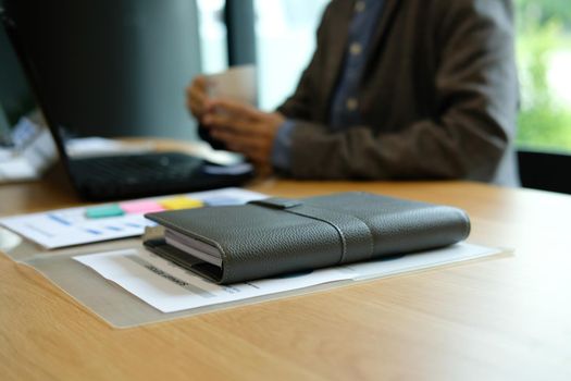 businessman with coffee cup working at workplace coworking office.