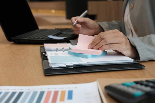 Businessman hold sticky notes reminder schedule for organizing plan at workplace