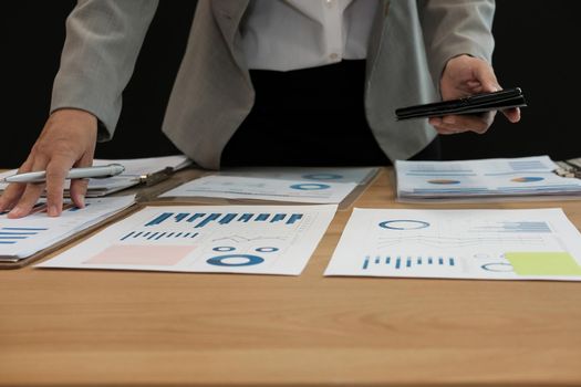 man working organizing plan with smart phone. businessman analyzing document at workplace coworking office