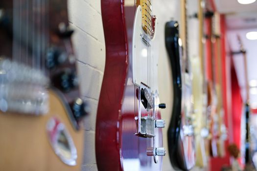 electric guitar hanging on white wall