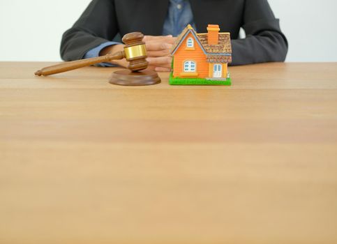 businessman lawyer with judge gavel & house model. buying selling & renting real estate property