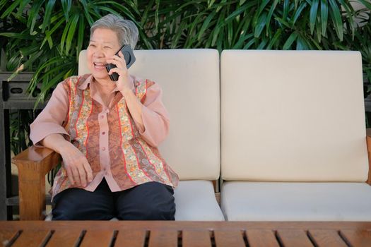 old elder woman talk on mobile phone. elderly senior speaking on smartphone. asian female have phone conversation