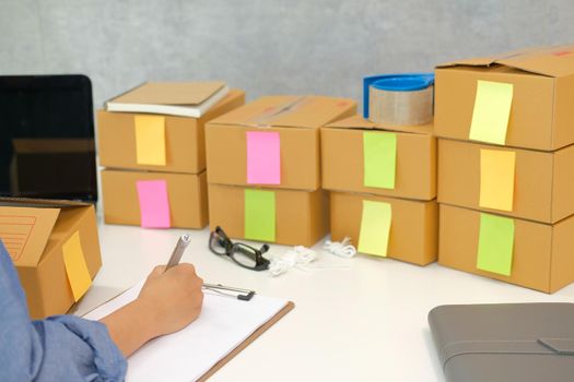 startup small business owner writing note. freelance man seller working at home.  Online selling, e-commerce concept