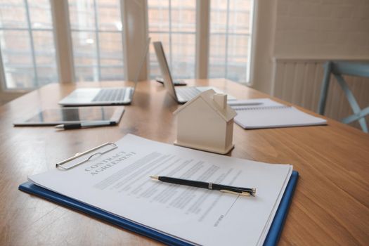 contract agreement, house architectural model. real estate & renting property concept