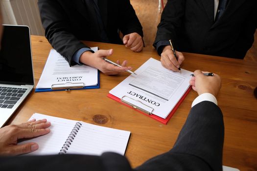 businessman consulting lawyer & signing contract agreement. team meeting at law firm
