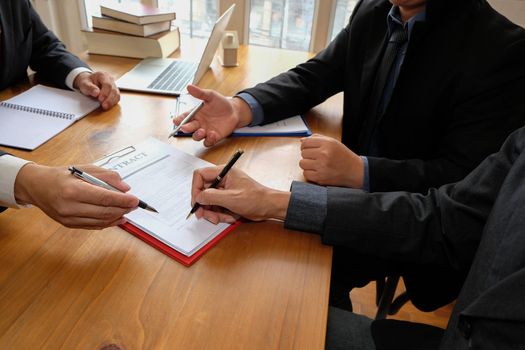 businessman consulting lawyer & signing contract agreement. team meeting at law firm