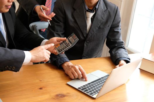 accountant discussing with businessman. internal auditor audit performance revenue. team meeting at office