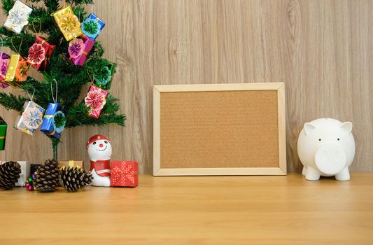 decorated christmas tree cork board & piggy bank. xmas new year holiday festival.