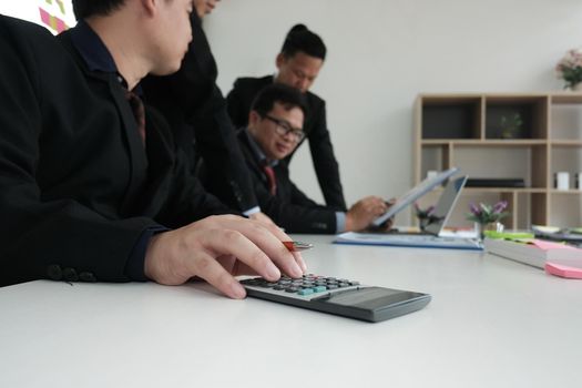business inspector analyze financial plan report. businessman using calculator to calculate budget. internal auditor audit performance revenue at office.