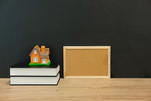 house home model cork board book on wooden desk. real estate property law