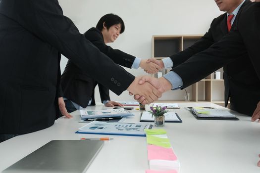 Business people shaking hands after finishing up a meeting. Two colleagues handshaking after conference. Greeting deal, teamwork, partnership, corporate concept.