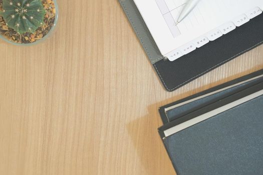 notebook book on wooden desk table. office workplace top view. education concept. succulent cactus plant in pot