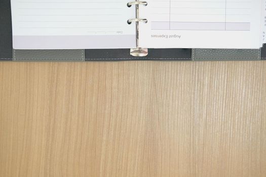 notebook on wooden desk table. office workplace top view. education concept