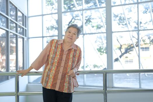 asian elder female woman resting relaxing on balcony terrace. elderly senior leisure lifestyle