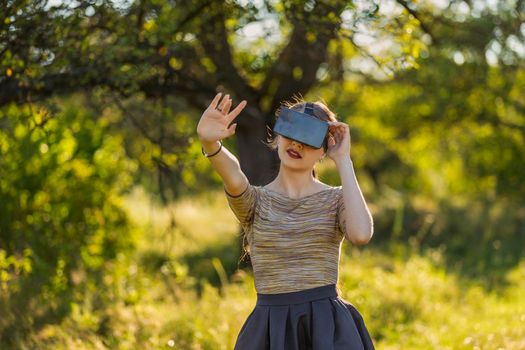 girl with virtual reality gadget in nature