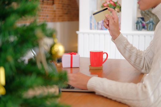 man holding credit card for online shopping. male buyer buying christmas gift on internet. new year holiday merry xmas celebration