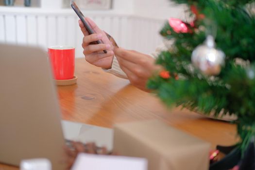 man holding credit card & smart phone for online shopping.  male buyer buying christmas gift on internet. merry xmas new year holiday celebration