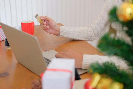 man holding credit card for online shopping. male buyer buying christmas gift on internet. new year holiday merry xmas celebration