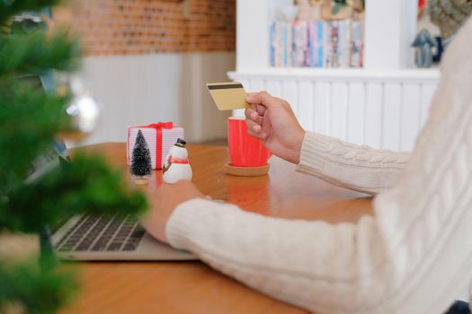 man holding credit card for online shopping. male buyer buying christmas gift on internet. new year holiday merry xmas celebration