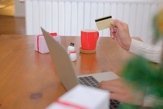 man holding credit card for online shopping. male buyer buying christmas gift on internet. new year holiday merry xmas celebration