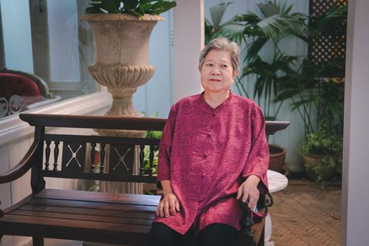 old elder woman resting in garden. asian elderly female relaxing in park. senior leisure lifestyle