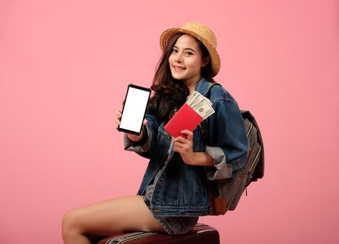 young asian woman backpacker traveler with passport money backpack. journey trip travel. studio shot