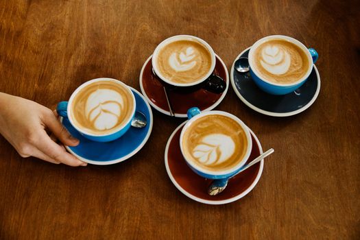 close up of cappuccino cup on table in a coffee shop cafe