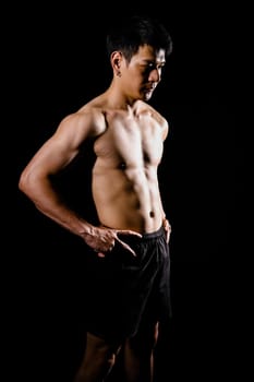 portrait of athletic muscular bodybuilder man with naked torso six pack abs. fitness workout concept