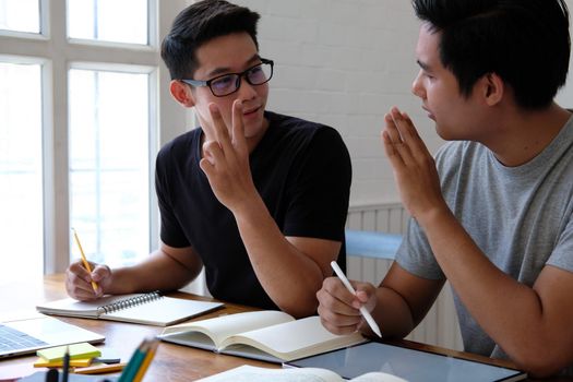 designer working on graphic tablet discussing creative idea of startup project with partner