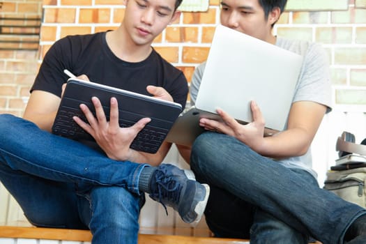 designer working on computer graphic tablet discussing creative idea of startup project with partner