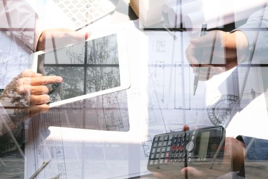 architect engineer team working on house blueprint of real estate project at workplace. building teamwork double exposure with crane at construction site